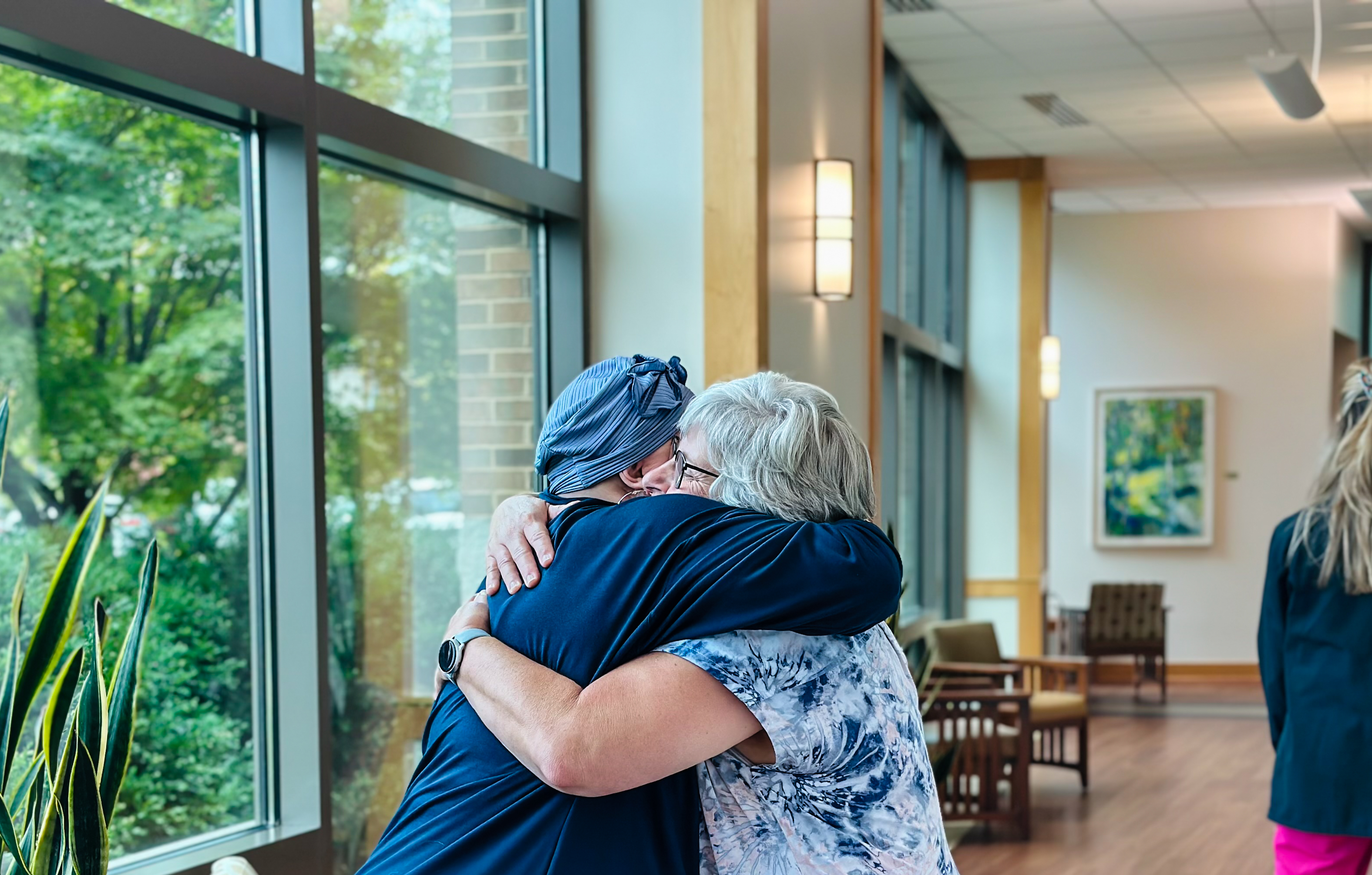 A Centra Caregiver hugs patient Sally O'Donnell.