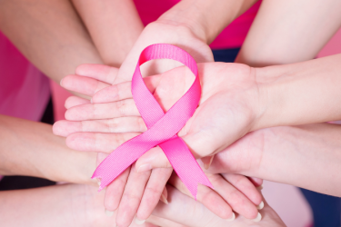 Hands with breast cancer ribbon